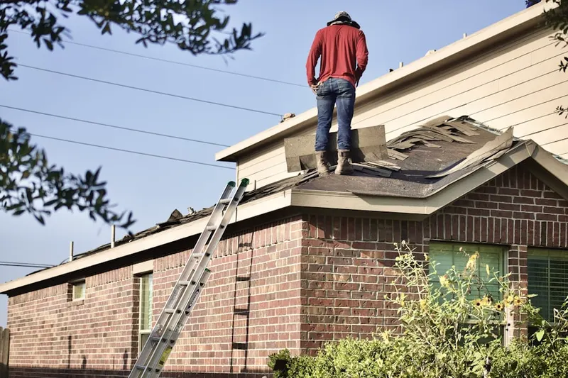 Professional roofer working on a residential roof in Mushroom Corner